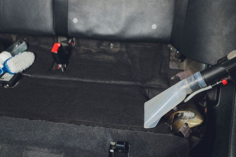 Cleaning the interior of a car with a carpet cleaner