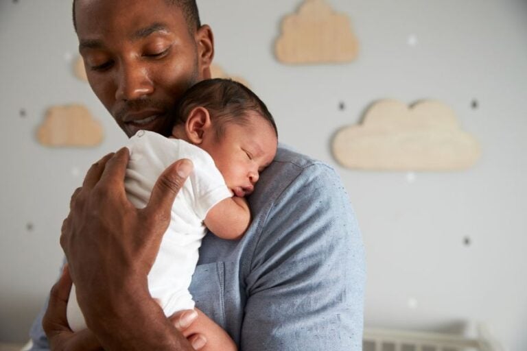 Tired Father Holding Baby While Standing