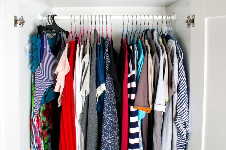 Men's and Women's Clothes Hanging in Wardrobe