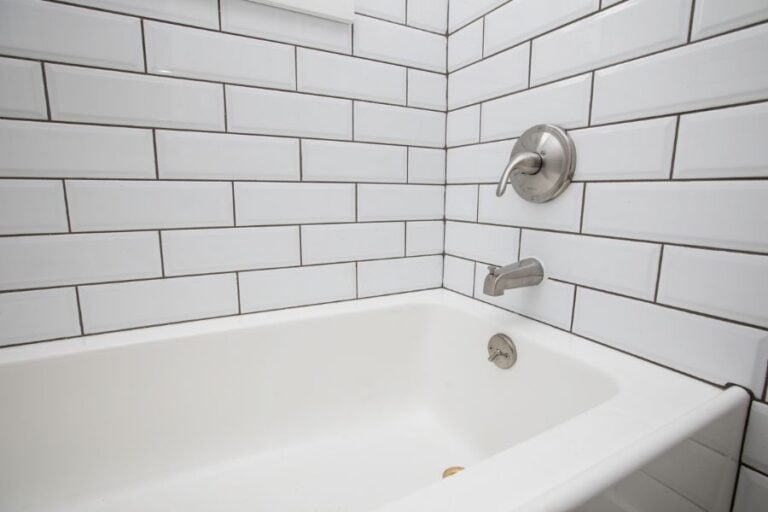 Bathtub With Subway Tile Surround and Faucet