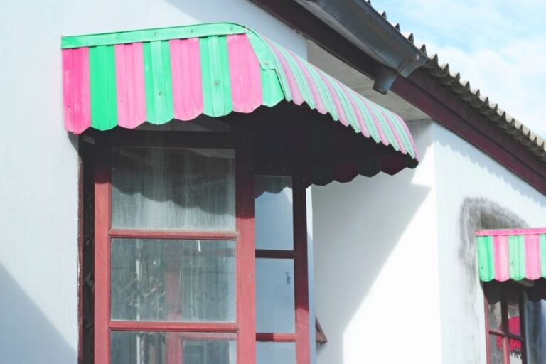 Old Red and Green Metal Awning Over Residential Window
