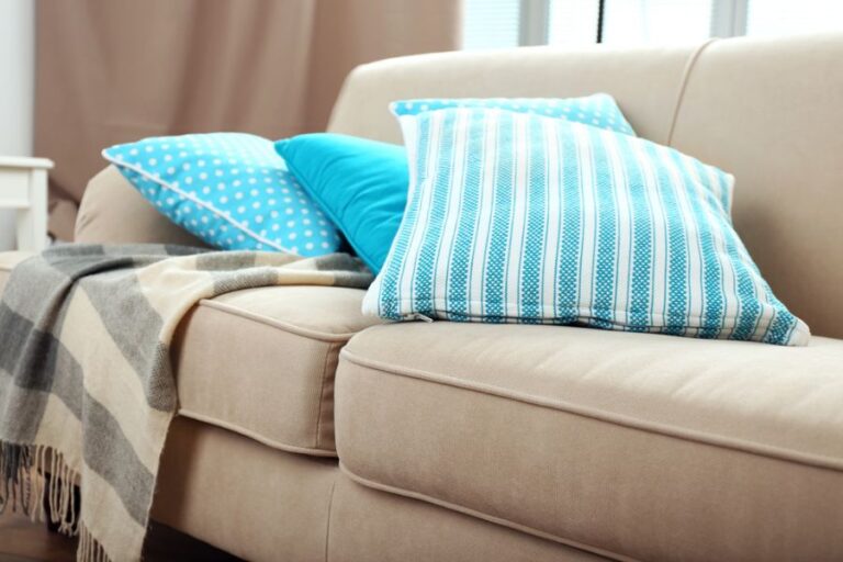Blue and White Pillows on Tan Couch Cushions