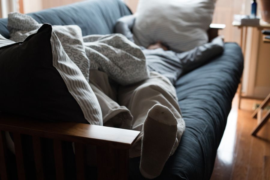 Exhausted Man Napping on a Couch