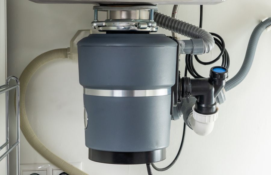 Gray Garbage Disposal Under a Kitchen Sink