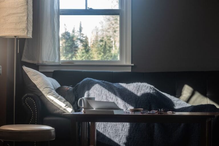 Man Napping on a Couch With the Sunlight Streaming In