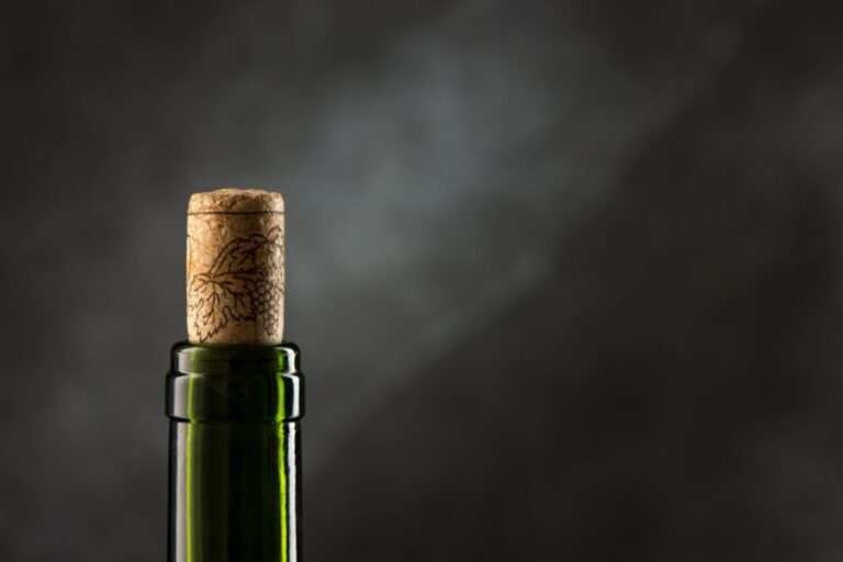Neck of a Green Wine Bottle With the Cork Sticking Out