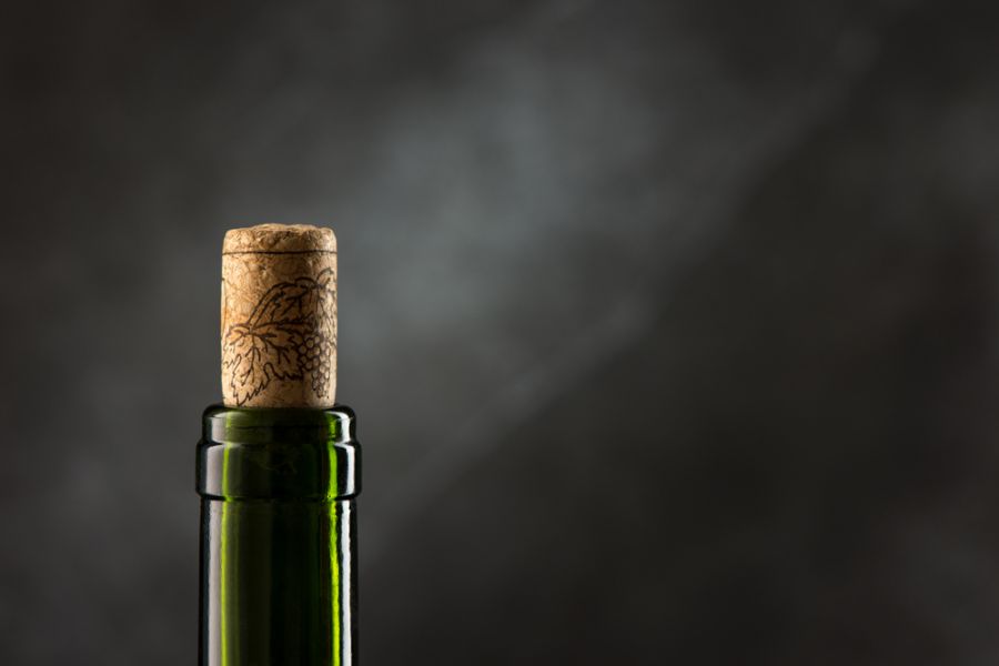 Neck of a Green Wine Bottle With the Cork Sticking Out
