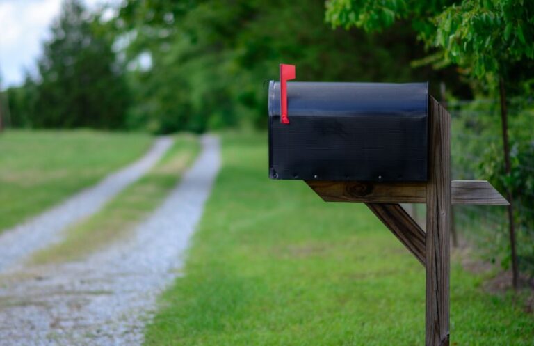 Large Black Mailbox Next to a Gravel Driveway