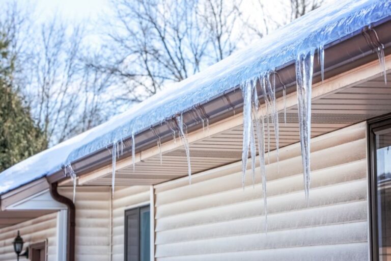 Ice Dam and Icicles on a Gutter of a Housev