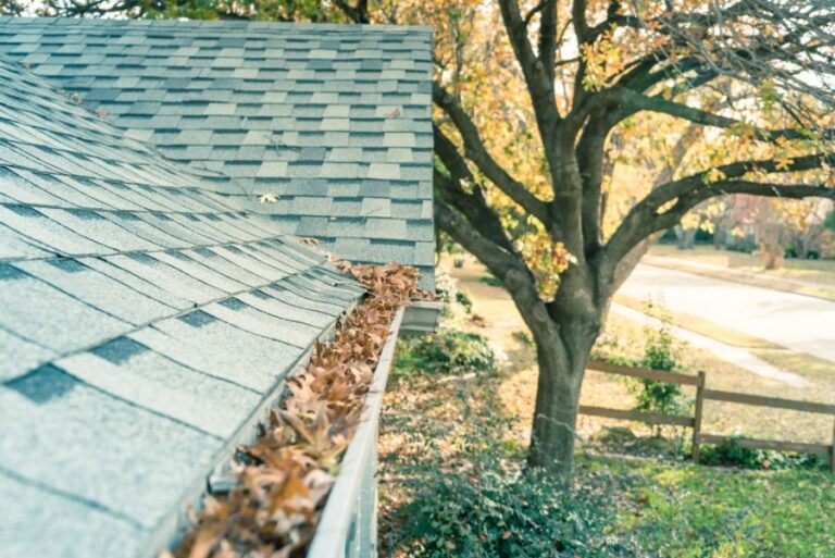 Rain Gutters on the Front of a House Clogged With Leaves