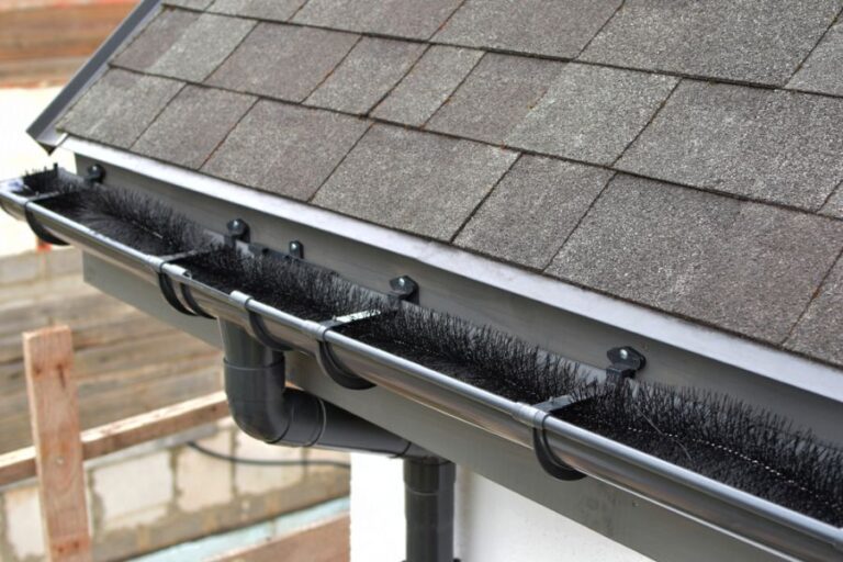 Black Plastic Gutter Brush in a Gutter to Catch Leaves