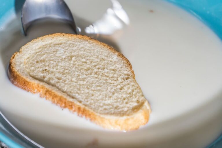 Bread Being Soaked in French Toast Milk Mixture