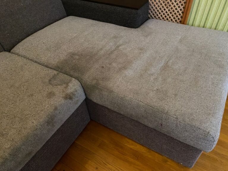 Sectional Couch With Several Stains on the Cushions