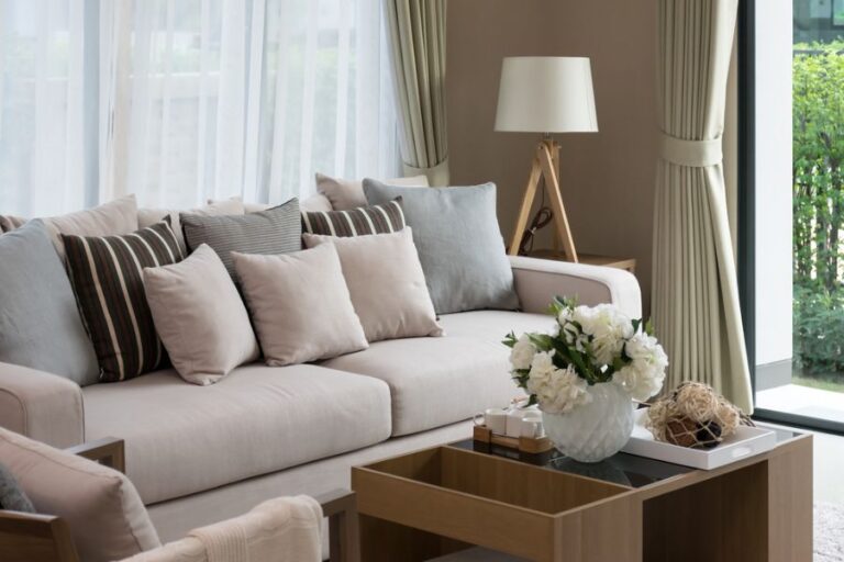 Tan Couch With Several Pillows in a Living Room