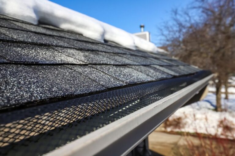 Closeup on Gutter on a House With Snow on the Roof