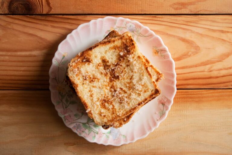 Small Stack of Fluffy French Toast on a Pink Plate