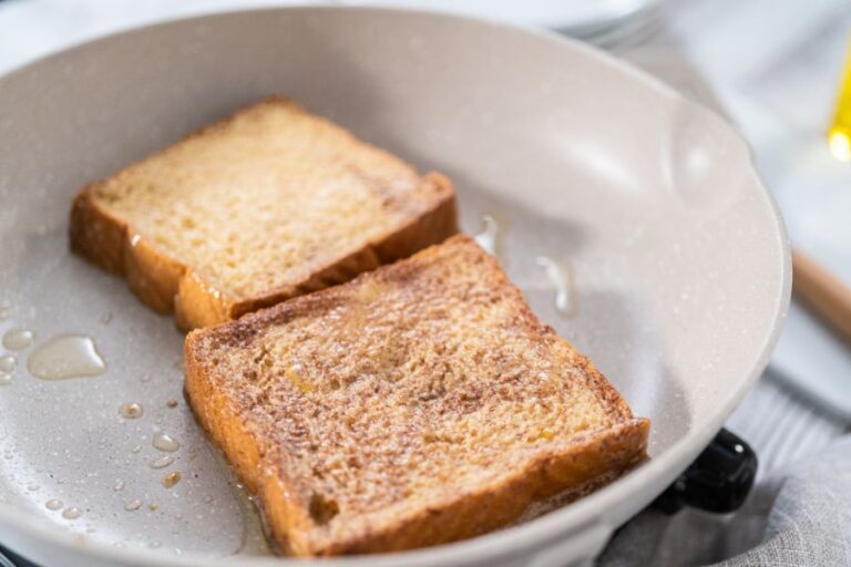 Two Pieces of French Toast Cooking in a Frying Pan