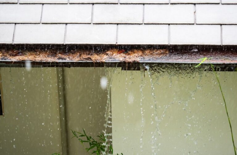Water Pouring From a Clogged Gutter During a Storm
