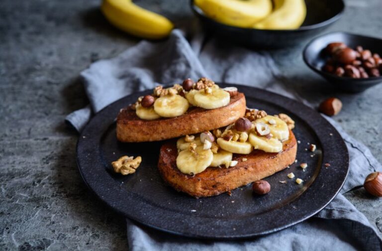 Cinnamon French Toast With Bananas, Walnuts, and Hazelnuts on a Blue Plate
