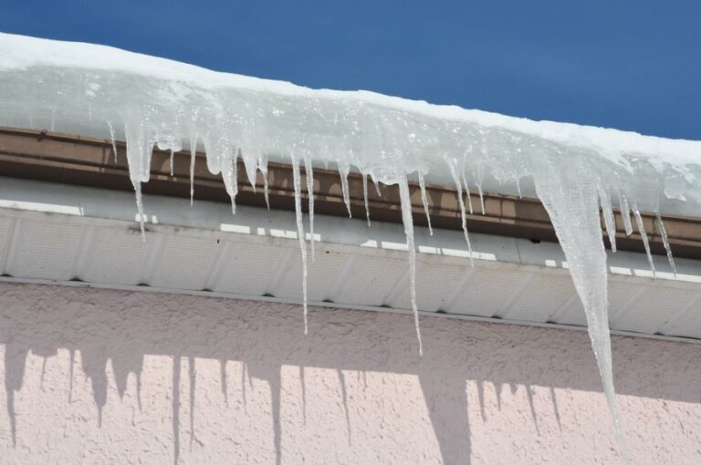 Icicles on an Ice Dam on the Edge of a Gutter