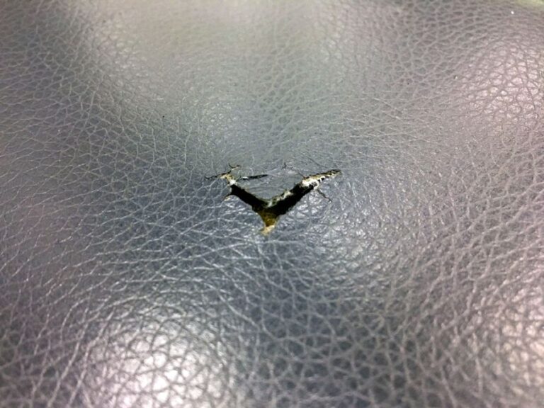 Leather Couch With Damage in the Form of a Tear