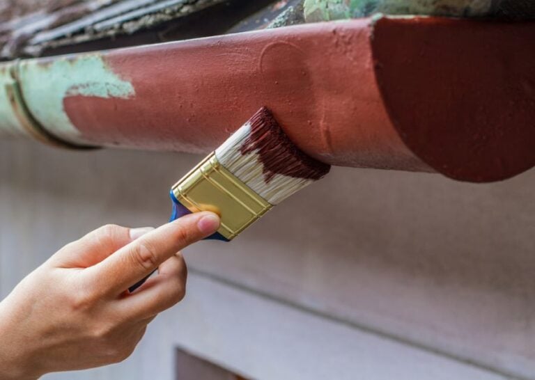Painting Gutters Red With a Paint Brush