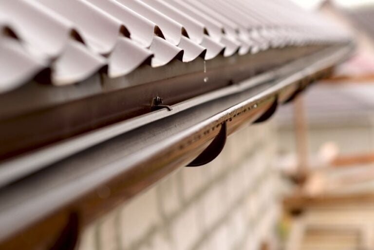 Water Dripping Off of Roof Into a Gutter