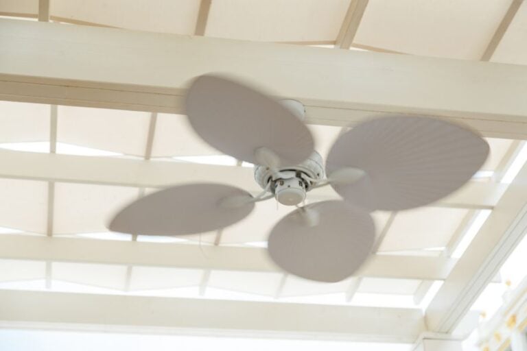 White Ceiling Fan Hanging From the Roof of a Pergola