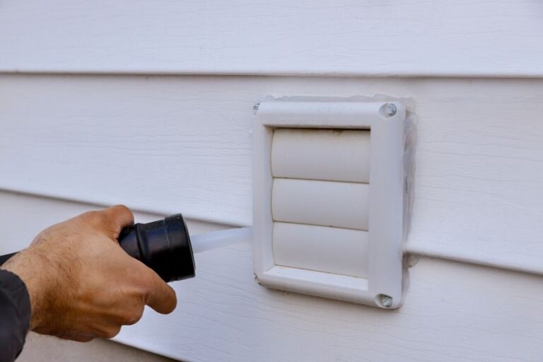 Applying Caulk on a New Outdoor Exhaust Vent