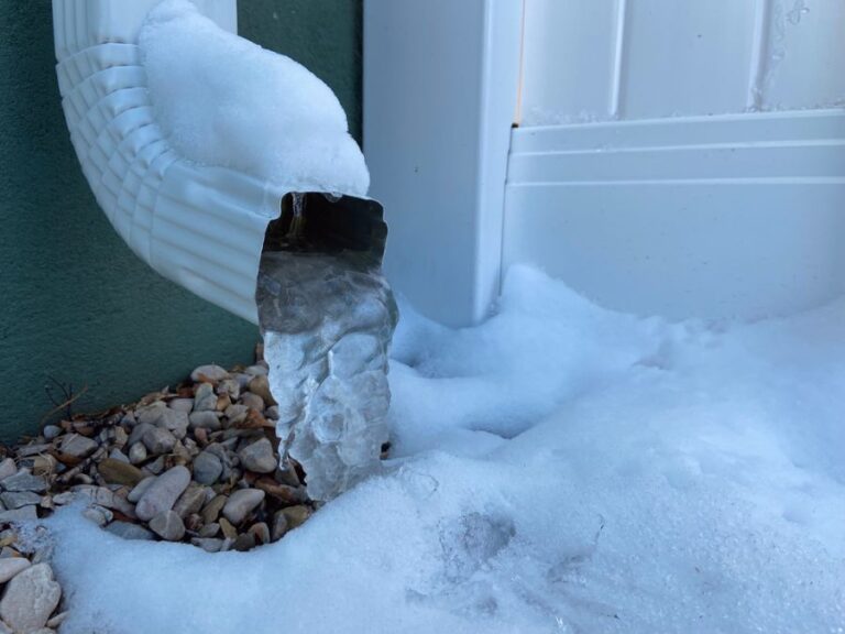 Frozen Downspout on the Side of a House in the Winter