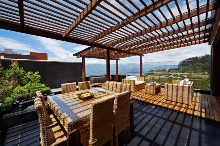 Large Wooden Pergola Over a Back Deck With a View of the Water