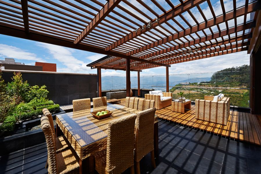 Large Wooden Pergola Over a Back Deck With a View of the Water