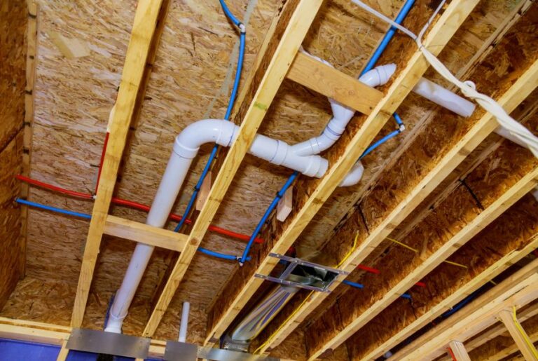 PEX and Drainage Pipes in the Ceiling of a Crawl Space