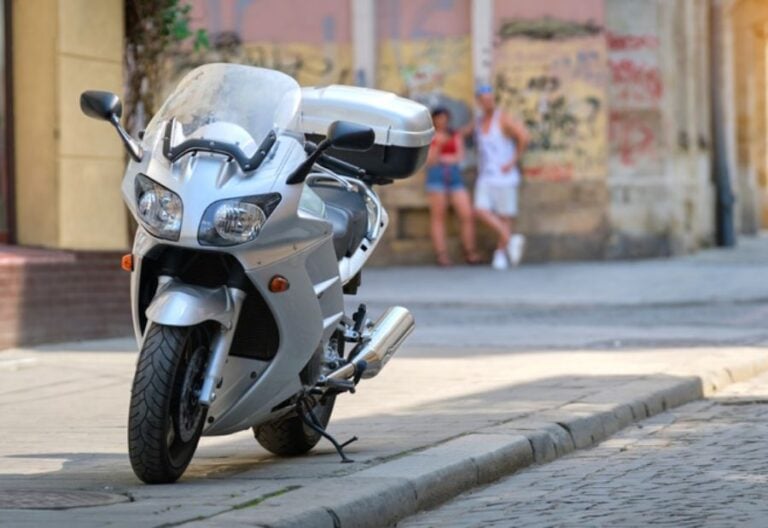 Motorcycle Parked on a Sidewalk on a City Street