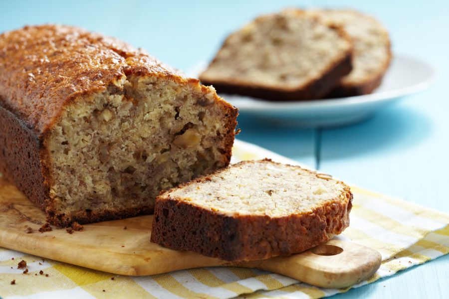 Banana Walnut Bread Sliced on a Cutting Board