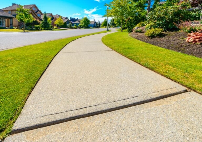 Curved Sidewalk Beside a Well Maintained Residential Street