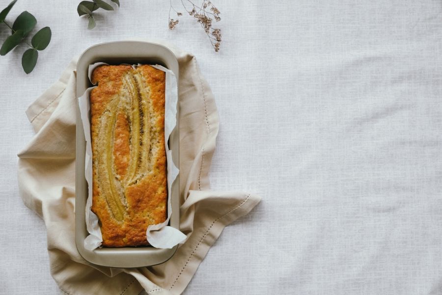 Fresh Baked Loaf of Banana Bread in a Pan on a Towel