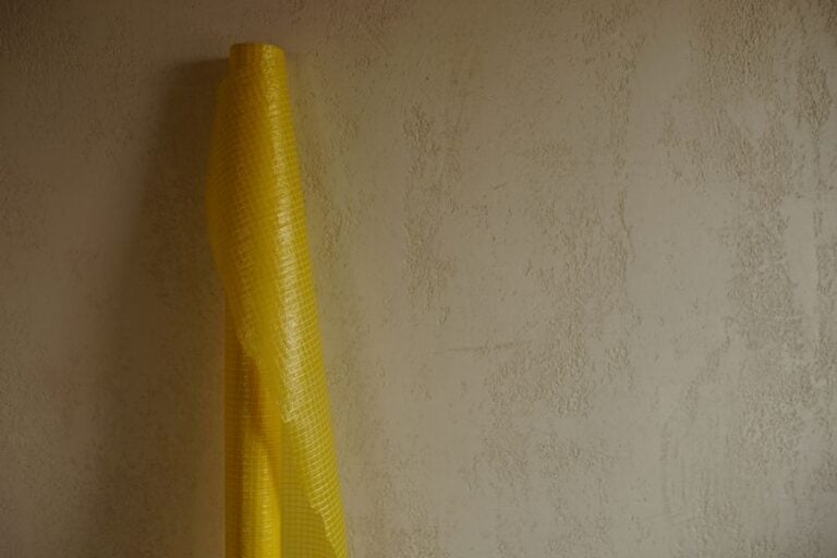 Roll of Yellow Vapor Barrier Leaning Against a Wall