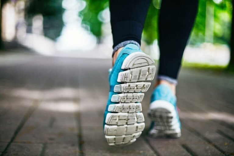 Woman Running on a Sidewalk