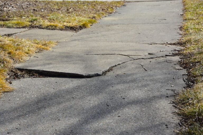 Cracked Sidewalk in Front of House